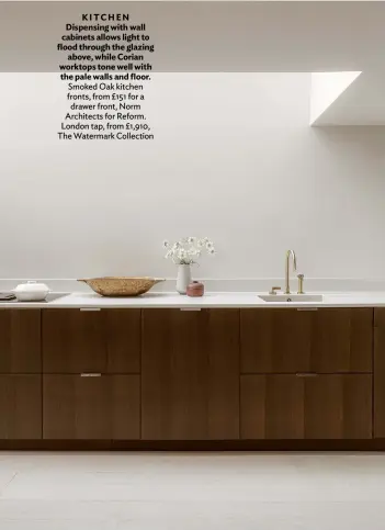  ??  ?? KITCHEN Dispensing with wall cabinets allows light to flood through the glazing above, while Corian worktops tone well with the pale walls and floor. Smoked Oak kitchen fronts, from £151 for a drawer front, Norm Architects for Reform. London tap, from £1,910, The Watermark Collection