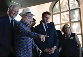  ?? (AP/Christophe Petit Tesson) ?? French President Emmanuel Macron (center) visits the newly inaugurate­d Shoah memorial at the former Pithiviers train station with Holocaust survivor Marcel Sztejnberg (second left) on Sunday in Pithiviers, France.