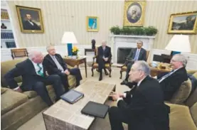  ??  ?? President Barack Obama and Vice President Joe Biden, background, on Tuesday meet with Senate officials, including Minority Leader Harry Reid, second from left, and Majority Leader MitchMcCon­nell, right. Carolyn Kaster, The Associated Press