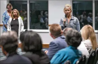  ?? PHOTOS BY ALLEN EYESTONE / THE PALM BEACH POST ?? Wellington resident Christy Moore, who attended the game at Palm Beach Central where shots were fired, directs a question to panel members. The meeting hosted by Rep. Lois Frankel focused on gun violence after shootings in Wellington and Jacksonvil­le.