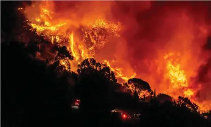  ?? Photograph: Kyle Grillot/AFP/Getty Images ?? The Cave fire burns on a hillside near Santa Barbara.