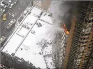  ?? KATHERINE BOURBEAU / AP ?? Flames emerge from the Strand apartment building near Times Square in New York in 2014. Experts recommend that residents of a building with proper protection­s shelter in place during high-rise fires.