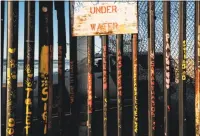  ?? Associated Press ?? A border patrol officer in his vehicle guards the border fence Wednesday as seen from Tijuana, Mexico. Nearly half of Americans identify immigratio­n as a top issue for the government to work on this year.