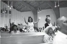  ?? Eamon Queeney / Washington Post ?? Phyllis White, center, stands as The Rev. Stephen Howard preaches a sermon during Sunday service at Cornerston­e Missionary Baptist Church in Elizabeth City, N.C.