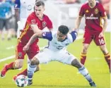  ?? CHRIS DETRICK/AP ?? Orlando City midfielder Cristian Higuita, center, battles Real Salt Lake forward Brooks Lennon, left, for the ball during the Lions’ 1-0 win over RSL Friday night in Sandy, Utah.