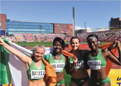  ??  ?? Molly Scott, Gina Akpe-Moses, Ciara Neville and Patience Jumbo-Gula celebrate after winning silver in the women’s 4x100m relay at the World U-20 Championsh­ips in Tampere, Finland