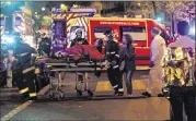  ?? THIERRY CHESNOT / GETTY IMAGES ?? Medics move a wounded man near the Boulevard des Filles-du-Calvaire after an attack Friday. The attacks came as France prepared for a major global climate conference in Paris in two weeks.