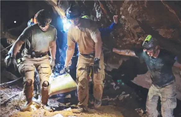  ?? Pictures: AFP PHOTO ?? Rescue personnel carrying a member of the "Wild Boars" Thai youth football team to safety inside the Tham Luang cave.