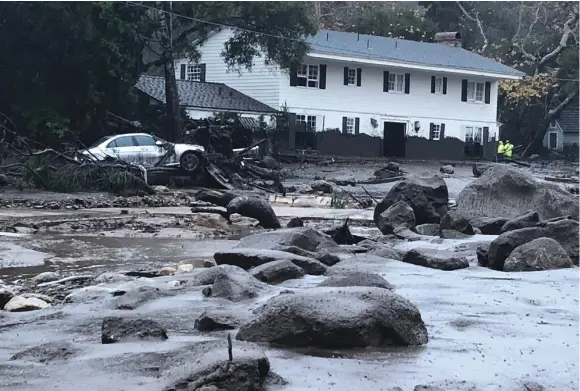  ??  ?? A STREET IN Montecito, California, after heavy rains caused a flow of mud and debris on Tuesday.