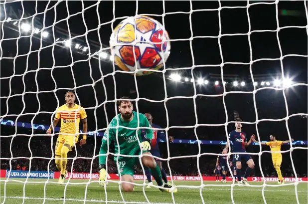  ?? - REUTERS ?? FC Barcelona’s Raphinha scores their second goal past Paris St Germain’s Gianluigi Donnarumma.