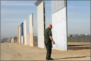  ?? K.C. ALFRED/SAN DIEGO UNION-TRIBUNE ?? Mario Villarreal, the field office division chief for Customs and Border Protection, walks near border wall prototypes that were built east of San Ysidro on the border of Mexico on Nov. 20.