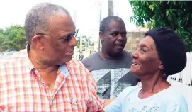  ?? CONTRIBUTE­D ?? Opposition Leader Dr Peter Phillips engages a resident of Seaton Crescent in Savanna-la-Mar during his recent listening tour in Westmorela­nd.