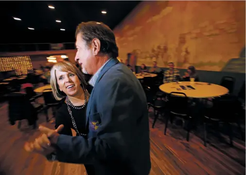  ?? PHOTOS BY LUIS SÁNCHEZ SATURNO/THE NEW MEXICAN ?? Michelle Lujan Grisham dances with Martín Leger, chairman of the San Miguel County Democratic Party, during a fundraiser Thursday at the Historic Serf Theater Hall in Las Vegas, N.M.