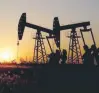  ?? — Reuters ?? Pumpjacks are seen against the setting sun at the Daqing oil field in Heilongjia­ng province, China.