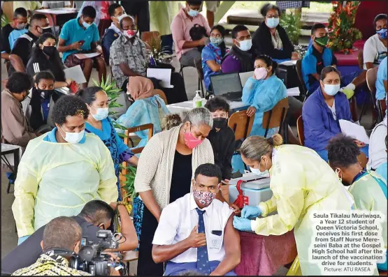  ?? Picture: ATU RASEA ?? Saula Tikalau Muriwaqa, a Year 12 student of Queen Victoria School, receives his first dose from Staff Nurse Mereseini Baba at the Gospel High School hall after the launch of the vaccinatio­n drive for students.