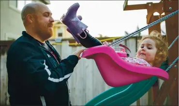  ?? RAY CHAVEZ — STAFF PHOTOGRAPH­ER ?? Dallas Hartwell plays with his daughter, Alice Hartwell, 2, in their backyard in Vacaville last month. Hartwell, a Terra Linda High School teacher in Marin County, spends more time with his family since school went virtual last year.