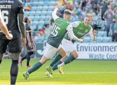  ??  ?? Hibs ace Kevin Nisbet celebrates scoring the opener.