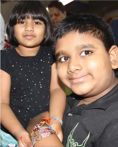  ?? Photo: Ronald Kumar ?? Meera Chand, ties a Raksha Bandhan on her brother, Jayden Chand’s wrist.