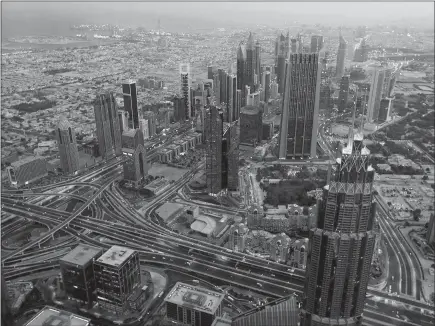  ?? AIJAZ RAHI / AP ?? A view of Shaikh Zayed highway towers is seen from the sky deck of world’s tallest building, Burj Khalifa in Dubai, United Arab Emirates. Despite its shimmering modernity, Dubai remains a conservati­ve society.