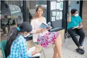  ??  ?? Claire Holba reads with young refugee students Aug. 18.