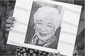  ?? JOE RONDONE/COMMERCIAL APPEAL ?? Brittany Baum holds a photo of her grandmothe­r Tillaya Lusky, who passed in December, at their family home in Memphis on May 7.