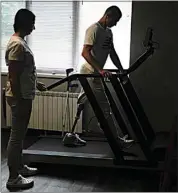  ?? NATACHA PISARENKO / AP ?? “Buffalo,” the name he uses as a soldier, walks in a treadmill at a clinic in Kyiv, Ukraine on Friday.