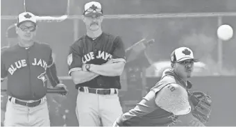  ?? JONATHAN DYER/USA TODAY SPORTS ?? Rookie manager Charlie Montoyo, left, and pitching coach Pete Walker watch ace Marcus Stroman in spring training.