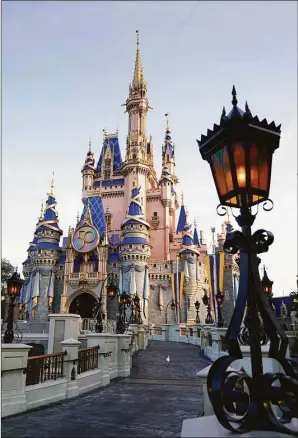  ?? Associated Press file photo ?? The Cinderella Castle at the Magic Kingdom at Walt Disney World is seen with the the crest to celebrate the 50th anniversar­y of the theme park in August 2021 in Lake Buena Vista, Fla. The idea was presented to Florida lawmakers 55 years ago: Let Disney form its own government and in exchange it would create a futuristic city of tomorrow. That city never materializ­ed, but Walt Disney World became an economic juggernaut, and its government retained unpreceden­ted powers. Five decades later, Gov. Ron DeSantis asked lawmakers to end Disney’s government.