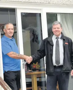  ??  ?? New door Ian Hyslop of Caledonian Windows with Frank Jones admiring the new patio door of his Darvel home