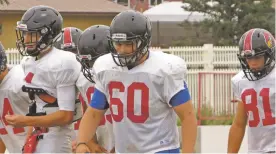  ??  ?? Offensive lineman Brooks Pavlic, center, returns to the Robertson trenches this season. His father was a former coach at New Mexico Highlands, but the family has recently moved back to Las Vegas, N.M., giving the top-ranked Cardinals an additional big...