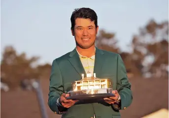  ??  ?? Japan’s Hideki Matsuyama poses with the trophy during the green jacket ceremony after winning the Masters at Augusta National Golf Club in Augusta, Georgia, on Sunday. He claimed a one-shot victory over American Will Zalatoris. — Reuters