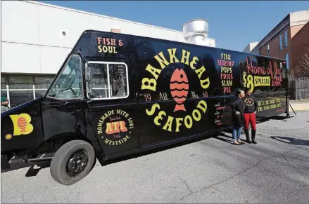  ?? CURTIS COMPTON /CCOMPTON@AJC.COM PHOTOS ?? The Bankhead Seafood food truck was unveiled at Frederick Douglass High School during a kickoff event for the business Thursday.