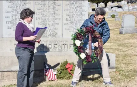  ?? JESI YOST - MEDIANEWS GROUP ?? The Boyertown Area Historical Society remembered the victims of the 1908Rhoads Opera House Fire with an annual wreath laying event at Fairview Cemetery in Boyertown on Sunday, Jan. 12. Pictured, Steven Grill, firefighte­r John Graver’s great grandson, places a wreath at the grave of the unidentifi­ed. Graver died in the line of duty and his sister Lottie died from injuries sustained from a second story fall from a window while escaping the fire.