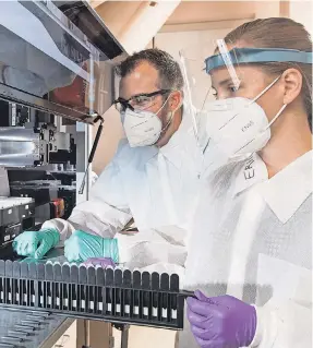  ?? JERRY NAUNHEIM JR./ AP ?? Matthew Meyer and Stephanie Knapik of C2N Diagnostic­s examine blood samples at the company’s facility in St. Louis.