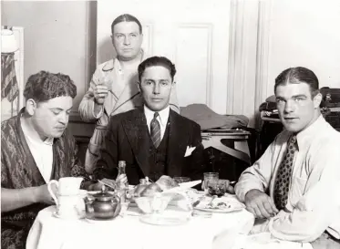  ?? Photo: LARRY BRAYSHER ?? DEBONAIR DICKSON: Jeff [centre, seated], pictured alongside legendary Georgia fighter Young Stribling [right]