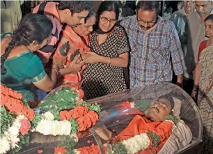  ?? AP ?? Relatives grieve around the body of Srinivas Kuchibhotl­a after the body was flown from the US to his residence on the outskirts of Hyderabad, on Tuesday. —