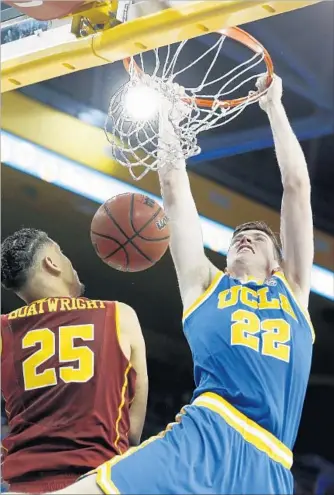  ?? Gary Coronado Los Angeles Times ?? FRESHMAN FORWARD TJ Leaf dunks over USC’s Bennie Boatwright in the first half at Pauley Pavilion. Leaf had 19 points and eight rebounds for UCLA; Boatwright had 20 and 10 for the Trojans.