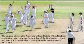  ??  ?? The umpire gives out to Australia's Brad Haddin (R) as England celebrates victory during the last day of the first Ashes cricket test match at Trent Bridge cricket ground in Nottingham, - REUTERS