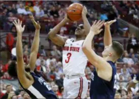  ?? JAY LAPRETE — THE ASSOCIATED PRESS ?? Ohio State’s C.J. Jackson, center, shoots over Penn State’s Josh Reaves, left, and Strath Haven All-Delco John Harrar Thursday in Columbus, Ohio. Ohio State beat Penn State, 74-70.