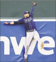  ?? Patrick Semansky / Associated Press ?? In this Aug. 31, 2015 file photo, Rays center fielder Kevin Kiermaier collides with the outfield wall after catching a fly ball by the Orioles’ Manny Machado in Baltimore.