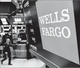  ?? Richard Drew Associated Press ?? WELLS FARGO stock has slipped into the red for the year. Since its search for a new leader began in March, the bank has lost nearly $24 billion in market value.