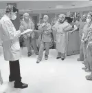  ??  ?? Dr. Jay Kaplan, left, speaks to staffers in New Orleans involved in the coronaviru­s fight during a “wellness visit,” designed to mitigate trauma in health care workers. JAY KAPLAN