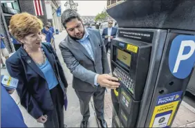  ?? Skip Dickstein / Times Union archive ?? Albany Parking Authority’s executive director Matthew Peter, right, seen here in 2017, was appointed to fill a seat in the Albany County Legislatur­e.