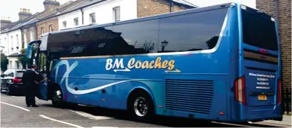  ??  ?? Unauthoris­ed: The coach that took Chinese tourists to a road near Grenfell Tower for photos