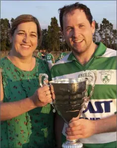  ??  ?? Aoife O’Connor, County Board Assistant Secretary and Shamrocks Secretary, presenting the trophy to her clubmate, Harry Goff.