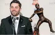  ?? [AP PHOTO] ?? Baker Mayfield stands next to the Davey O’Brien National Quarterbac­k Award during a news conference at the Fort Worth Club in Fort Worth, Texas on Monday.