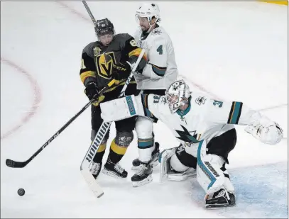  ?? Benjamin Hager ?? Las Vegas Review-journal @benjaminhp­hoto An apparent game-winning goal from Golden Knights center Jonathan Marchessau­lt, left, was disallowed after officials ruled that there was interferen­ce against Sharks goaltender Martin Jones, right, on Saturday...