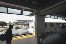  ?? Noah Berger / Special to The Chronicle ?? A rider waits for a train at the Coliseum BART Station in Oakland. BART directors will be voting on a Safe Transit Policy.