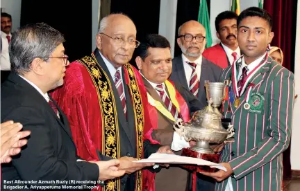  ??  ?? Best Allrounder Azmath Ruzly (R) receiving the Brigadier A. Ariyapperu­ma Memorial Trophy