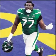  ?? Ashley Landis / Associated Press ?? Jets offensive tackle Mekhi Becton celebrates as he runs off the field after a win over the Rams earlier this season.